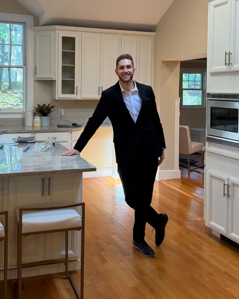 Jared smiling and leaning on a kitchen island